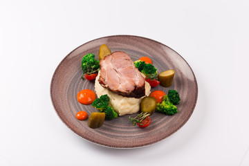 Front and top view isolated - The slow cook recipe with chilli pepper, mashed potatoes, broccoli and pickled cucumber.