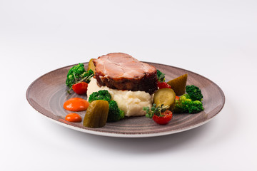 Front and top view isolated - The slow cook recipe with chilli pepper, mashed potatoes, broccoli and pickled cucumber.