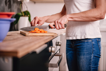 Woman cutting carrot