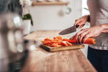 Woman cutting carrot