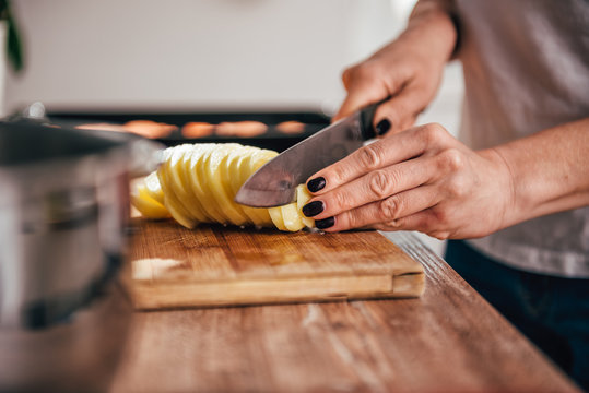 Woman cutting potato