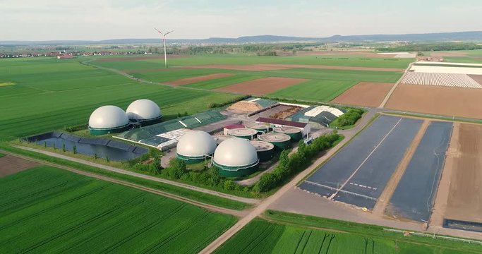 Camera flight over biogas plant from pig farm. Renewable energy from biomass. Modern agriculture European Union. aerial view, panoramic view from the air