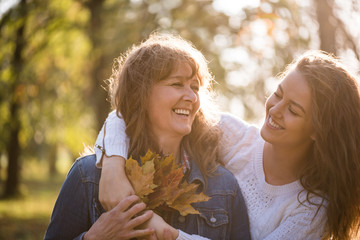 Daughter hugging her mother from behind