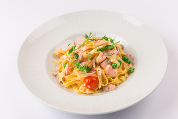 Front and top view isolated - Tagliatelle with salmon and tomatoes. 