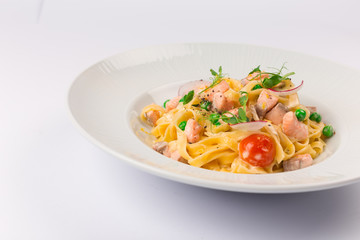Front and top view isolated - Tagliatelle with salmon and tomatoes. 