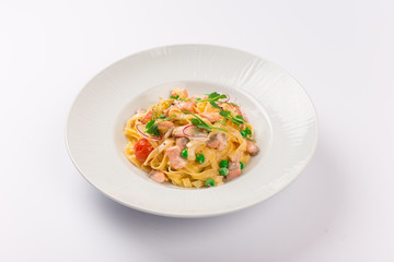 Front and top view isolated - Tagliatelle with salmon and tomatoes. 