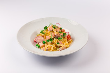 Front and top view isolated - Tagliatelle with salmon and tomatoes. 