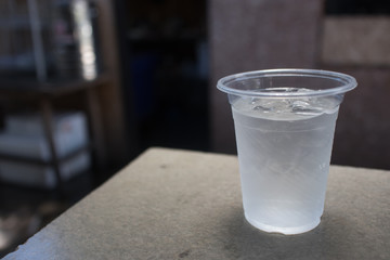 Water in a plastic glass on the table