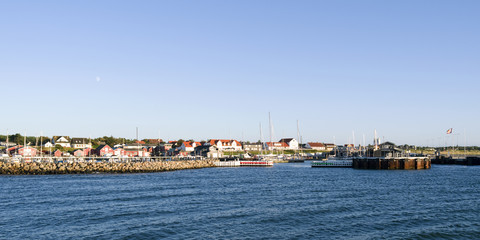 Fototapeta na wymiar Laesoe / Denmark: View from the outer breakwater of the ferry port basin to the entrance of the fishing port and the marina in Vesteroe Havn