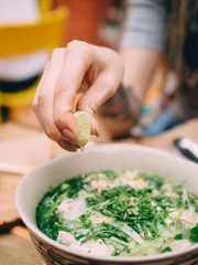 Foto op Canvas Vietnamese cuisine soup Pho Ga with chicken, noodles, fresh herbs and sauce in a bowl © paulzhuk