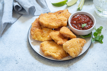 Fried crispy chicken nuggets with sauce