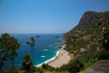 Fototapeta na wymiar Sand, wild beach coast with sea or ocean and mountain rocks
