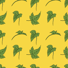 Seamless texture of green leaves. Hand drawn illustration on yellow background