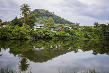 Lake Reflection in the Phuket, Thailand. Surface of lakes like a mirror reflect the image above, double image of landscape. 