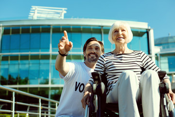 Just look. Charming blonde woman expressing positivity and looking forward while being in her wheelchair