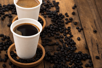 Coffee in paper cup on wood

