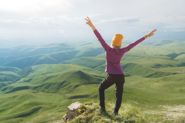 Young woman feeling strong and confident on the outdoor against green valley