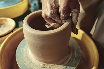 Creating a jar or vase of white clay close-up. Master crock.