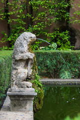 Seville, Spain - June 2018: The fountain in the park of the Alcazar palace in Seville, Spain, Europe.