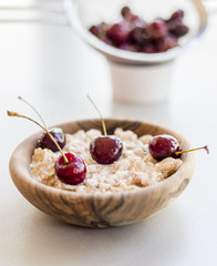 Fresh ripe bird cherries with porridge close up shot
