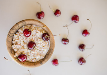Fresh ripe bird cherries with porridge close up shot