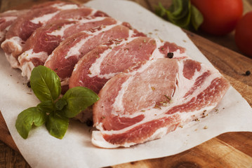 Raw pork meat with spices, wooden cutting board. Food Cooking Ingredient. Top view with copyspace.