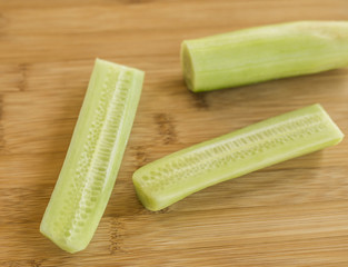 Sliced cucumber on wooden board
