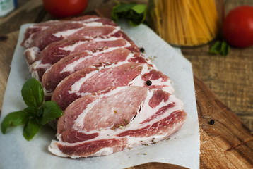Raw pork meat with spices, wooden cutting board. Food Cooking Ingredient. Top view with copyspace.