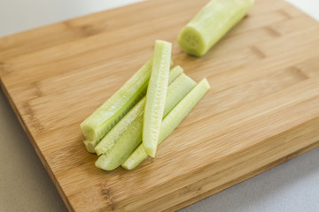 Sliced cucumber on wooden board