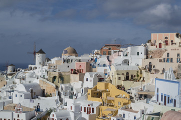 Fototapeta na wymiar Whitewashed Houses and Windmill on Cliffs with Sea View in Oia, Santorini, Cyclades, Greece