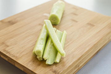 Sliced cucumber on wooden board