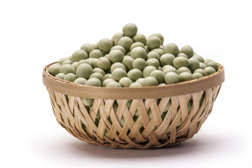 Green peas in cane basket isolated on white background