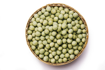 Green peas in cane basket isolated on white background