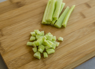 Sliced cucumber on wooden board