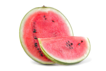 A large ripe half of a watermelon and a slice next to a white background. isolated