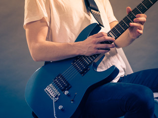 Close up of man playing on electric guitar