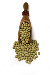 Green peas in wooden scoop spoon isolated on white background