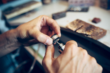 Different goldsmiths tools on the jewelry workplace. Jeweler at work in jewelry.