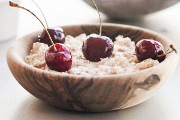 Fresh ripe bird cherries with porridge close up shot
