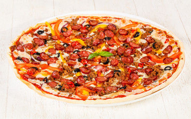 Pizza with sausages and minced meat