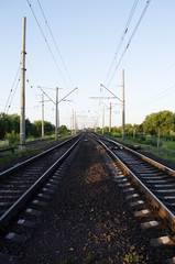 Fototapeta na wymiar Electrified double-track railway at sunset