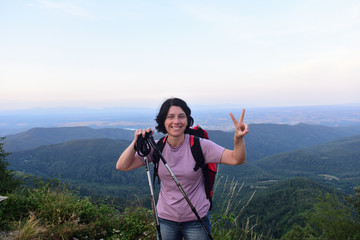 happy hiker woman to get to the top