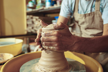 Creating a jar or vase of white clay close-up. Master crock.