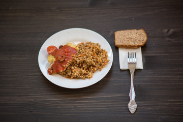 photo of a real meal on a dark background on a white plate.
