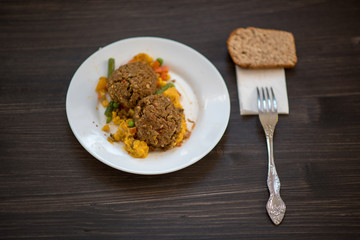 photo of a real meal on a dark background on a white plate.