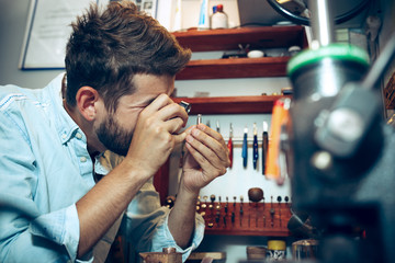 Different goldsmiths tools on the jewelry workplace. Jeweler at work in jewelry.