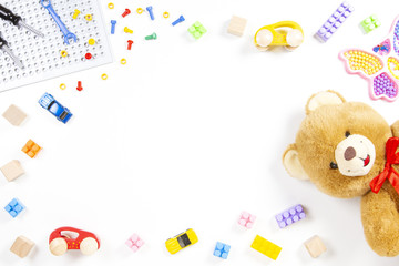 Colorful kids toys frame. Teddy bear toy tools cubes blocks cars on white background