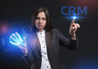 The concept of business, technology, the Internet and the network. A young entrepreneur working on a virtual screen of the future and sees the inscription: CRM
