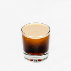 Nitrogen Infused Cold Brew Coffee in a clear glass on a white  background.