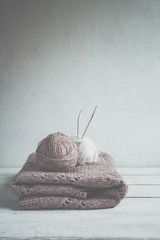 Tubes of wool thread and knitting needles for knitting handmade hobby in Scandinavian style monochrome with copy space